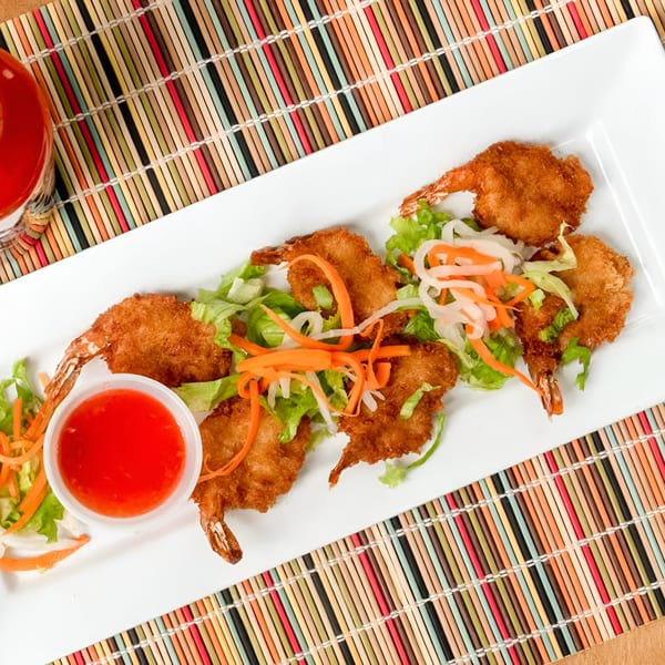 Teabreak Pho & Boba's crispy fried shrimp with sweet chili sauce, lettuce, and pickled vegetables on a white plate.